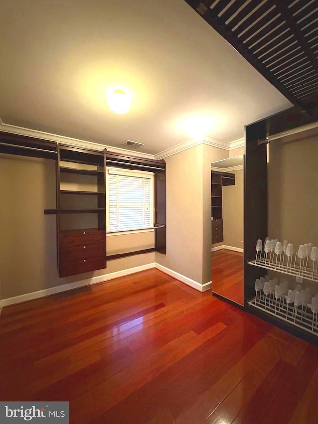 interior space featuring crown molding and hardwood / wood-style flooring