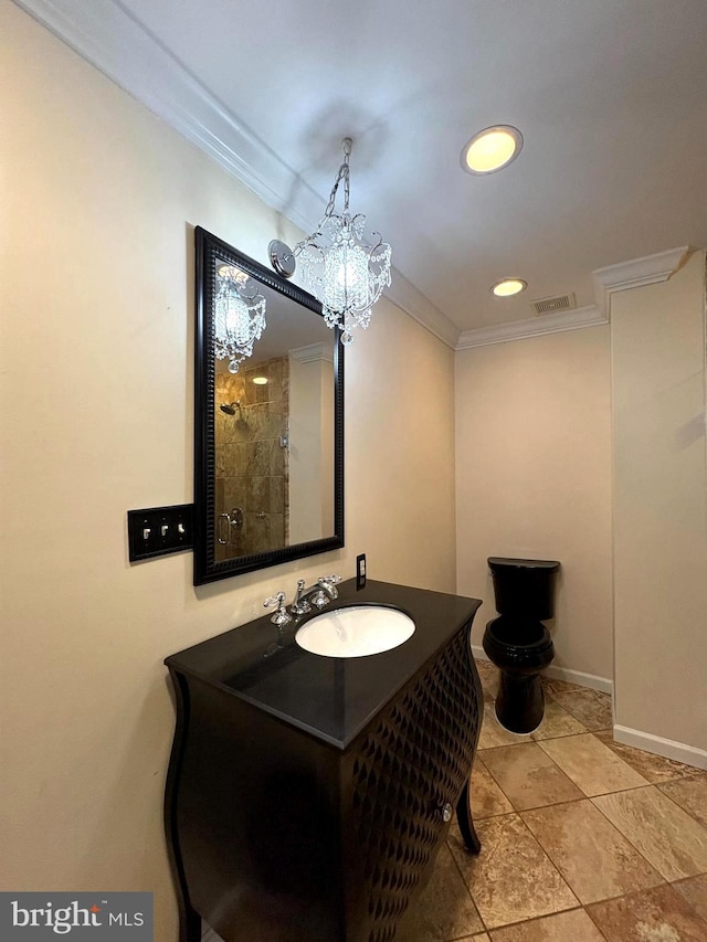 bathroom with ornamental molding and vanity