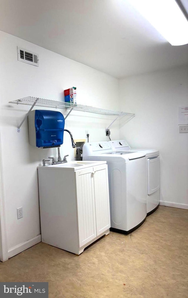 clothes washing area with washer and clothes dryer