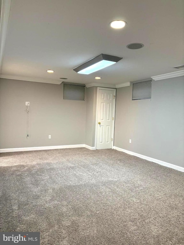 basement featuring ornamental molding and carpet flooring