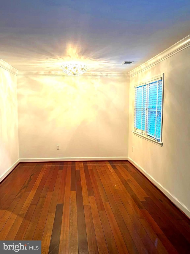 spare room with ornamental molding and hardwood / wood-style floors