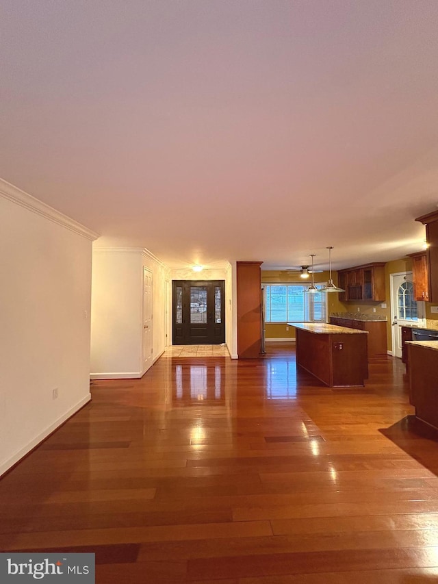 unfurnished living room with crown molding and dark hardwood / wood-style floors