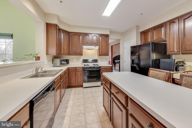 kitchen featuring light tile patterned flooring, appliances with stainless steel finishes, and sink