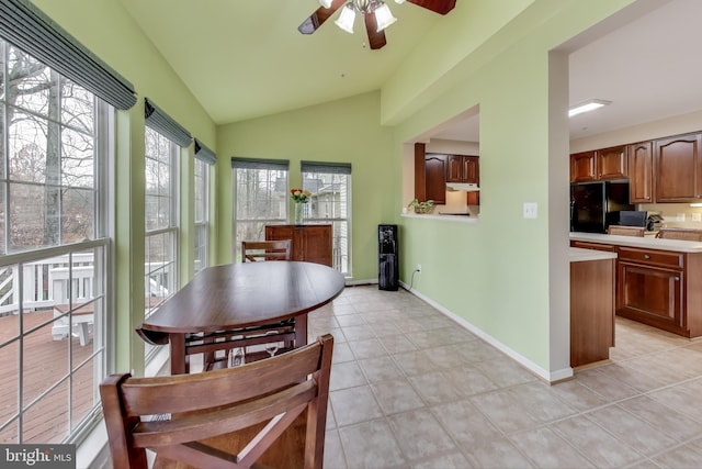 sunroom / solarium featuring ceiling fan, plenty of natural light, and lofted ceiling