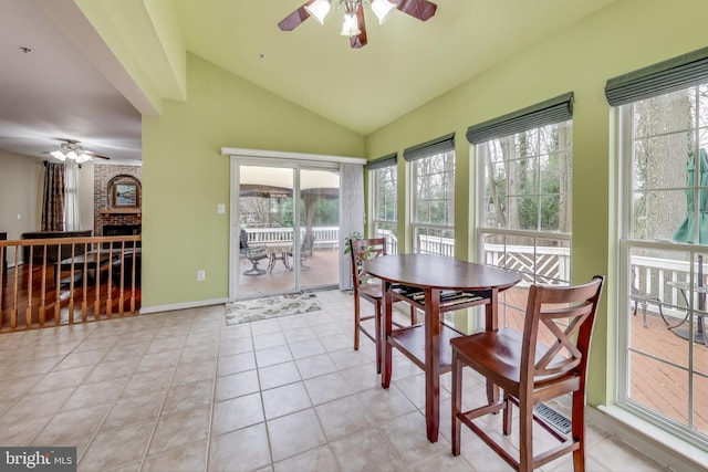 sunroom / solarium featuring a fireplace, ceiling fan, plenty of natural light, and lofted ceiling