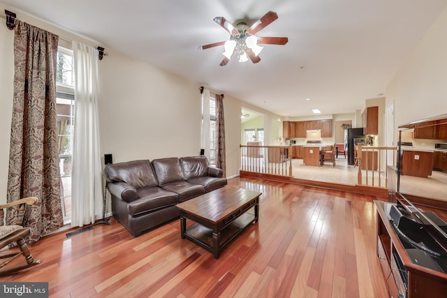 living room featuring ceiling fan and light wood-type flooring