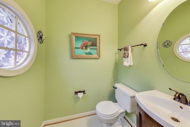 bathroom with tile patterned flooring, vanity, and toilet