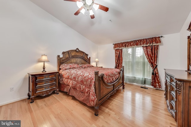 bedroom with light hardwood / wood-style floors, ceiling fan, and lofted ceiling