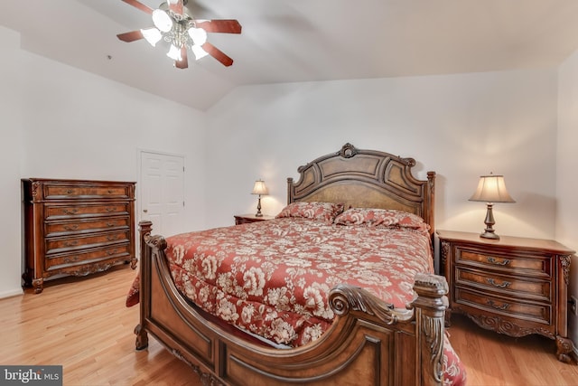 bedroom with ceiling fan, vaulted ceiling, and light hardwood / wood-style flooring