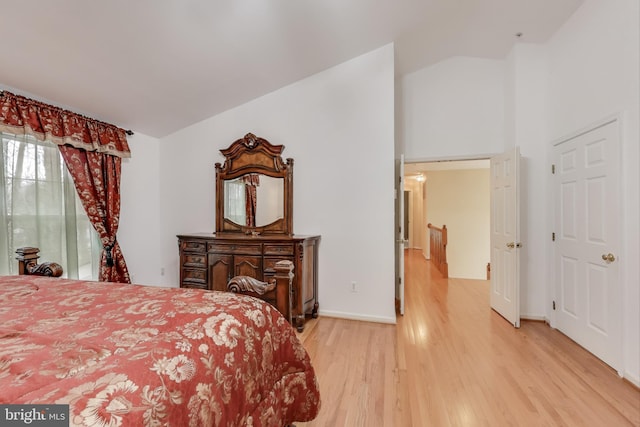 bedroom featuring hardwood / wood-style floors and vaulted ceiling