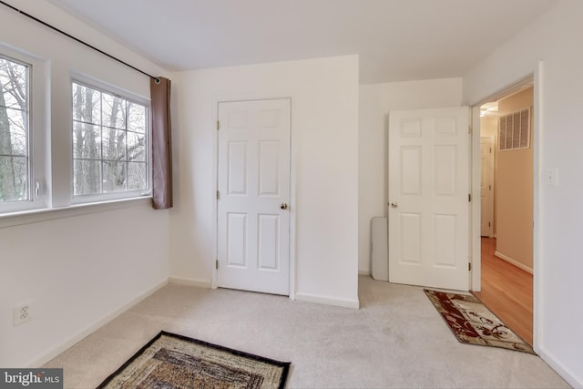 bedroom featuring light colored carpet