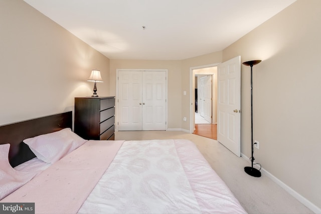 bedroom featuring light carpet and a closet