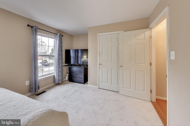 carpeted bedroom with a closet