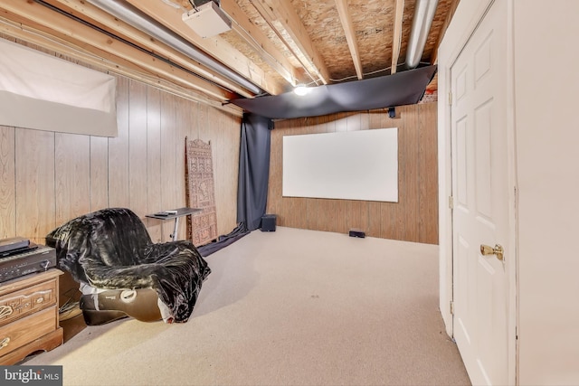 carpeted cinema room with wood walls