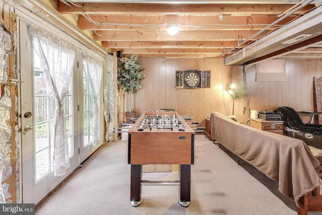 playroom with wood walls, french doors, and light colored carpet