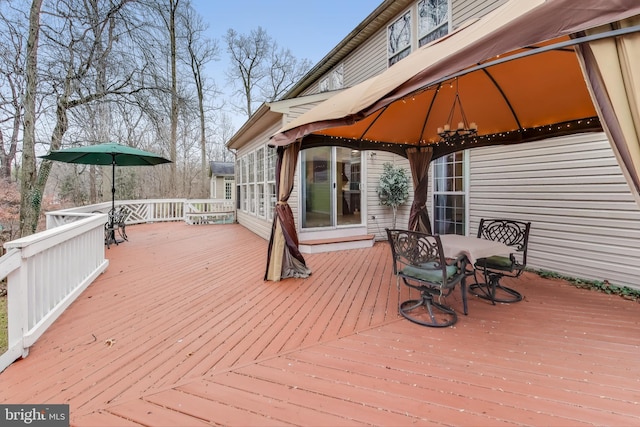 wooden terrace featuring a gazebo