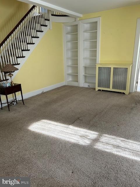 unfurnished living room with carpet flooring