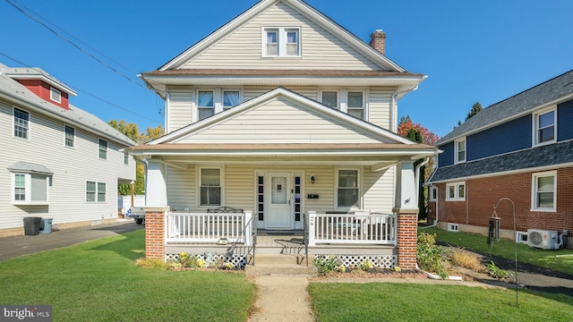 view of front facade with a front lawn and covered porch