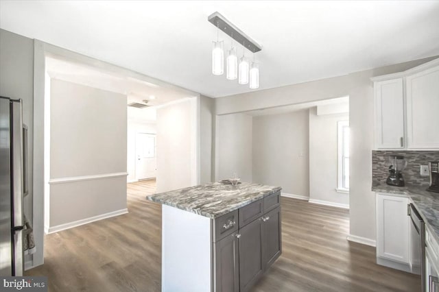 516 Harwood Ave, Baltimore, MD 21212 - kitchen with baseboards, wood finished floors, a kitchen island, white cabinets, and light stone counters