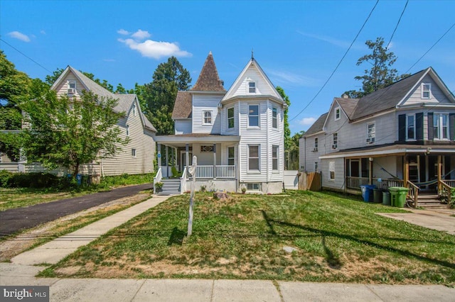 victorian home with covered porch and a front yard