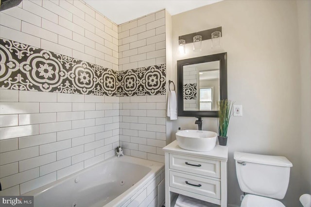 bathroom featuring vanity, toilet, and a tub