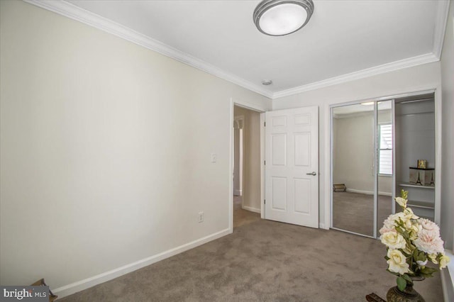 unfurnished bedroom with a closet, carpet, and ornamental molding