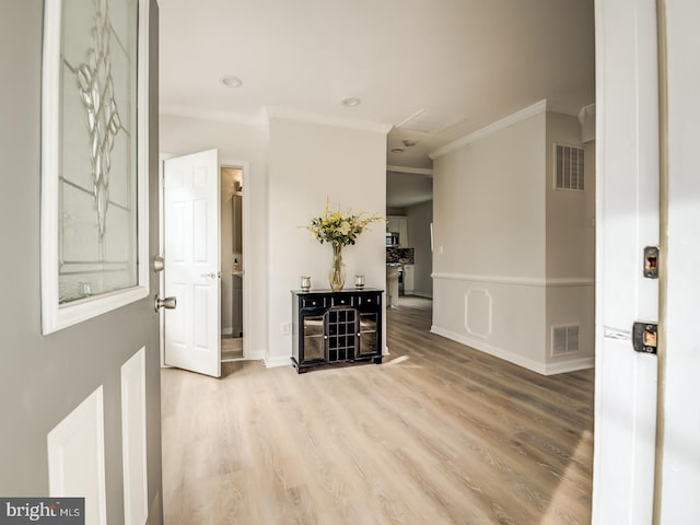 corridor featuring hardwood / wood-style flooring and crown molding