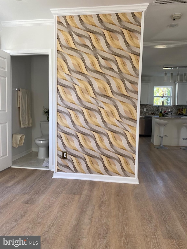 516 Harwood Ave, Baltimore, MD 21212 - hallway featuring ornamental molding, wood finished floors, and baseboards