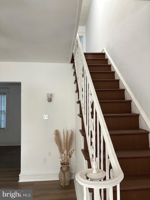 stairway featuring hardwood / wood-style floors