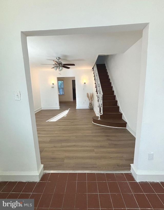 stairway with hardwood / wood-style flooring and ceiling fan