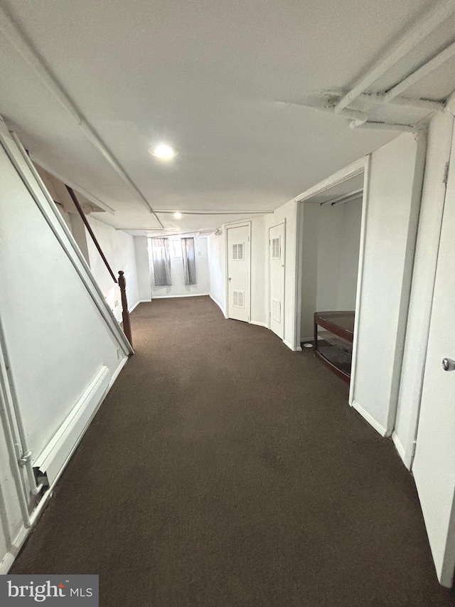 basement featuring dark colored carpet