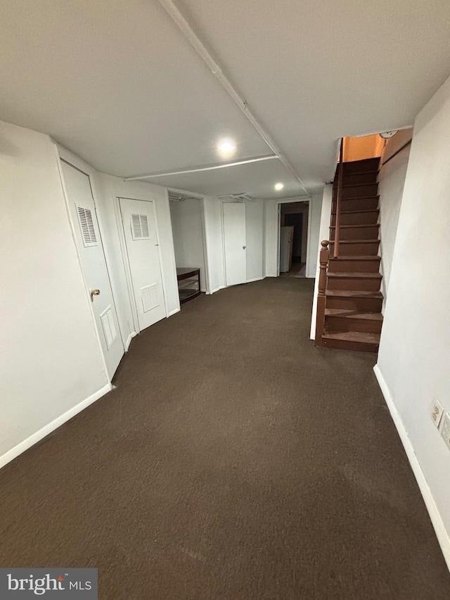 basement with dark colored carpet