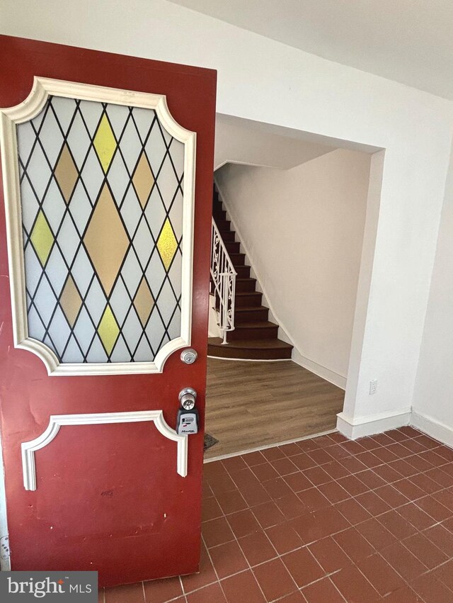 staircase with wood-type flooring