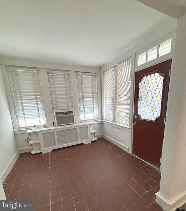 entryway with a healthy amount of sunlight, cooling unit, and radiator heating unit