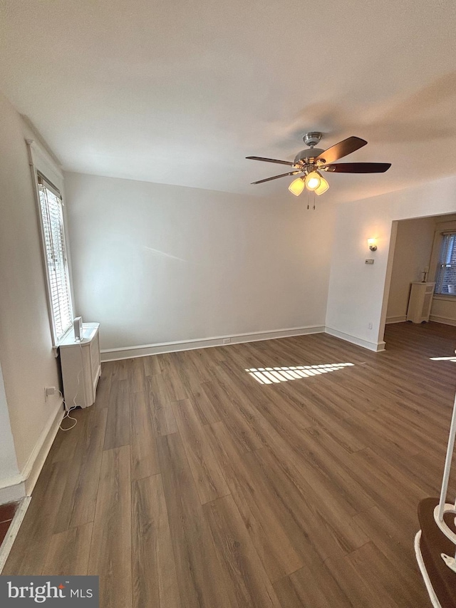 unfurnished room featuring ceiling fan and dark hardwood / wood-style flooring