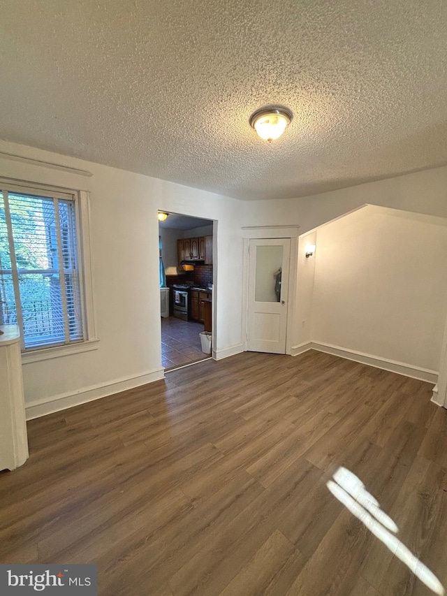 interior space featuring dark wood-type flooring and a textured ceiling