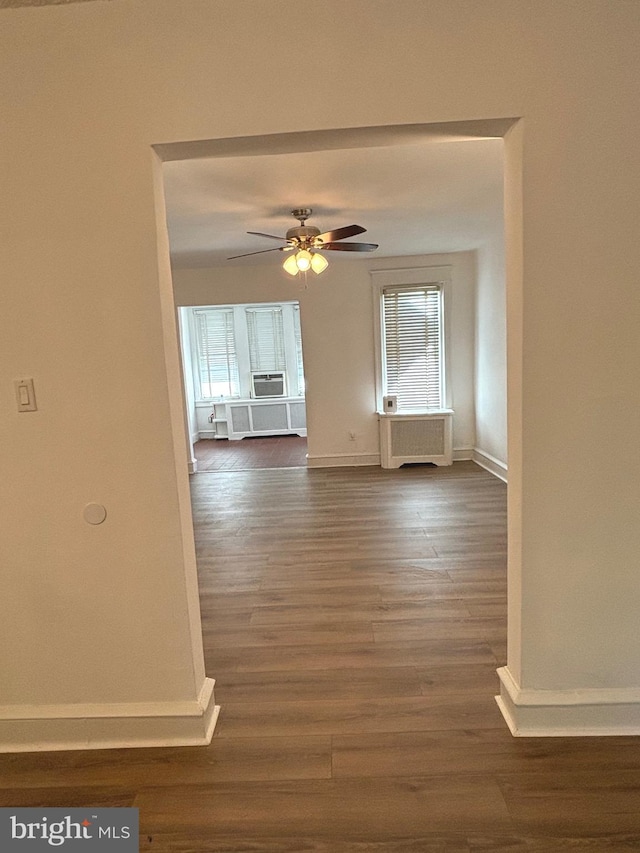 spare room with ceiling fan and dark hardwood / wood-style flooring