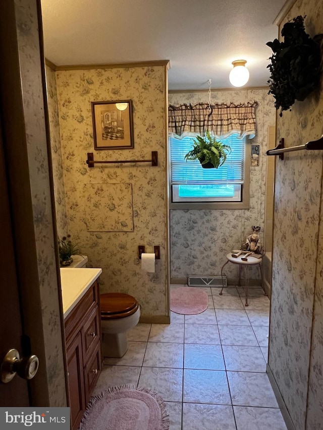 bathroom with tile patterned flooring, vanity, a textured ceiling, and toilet