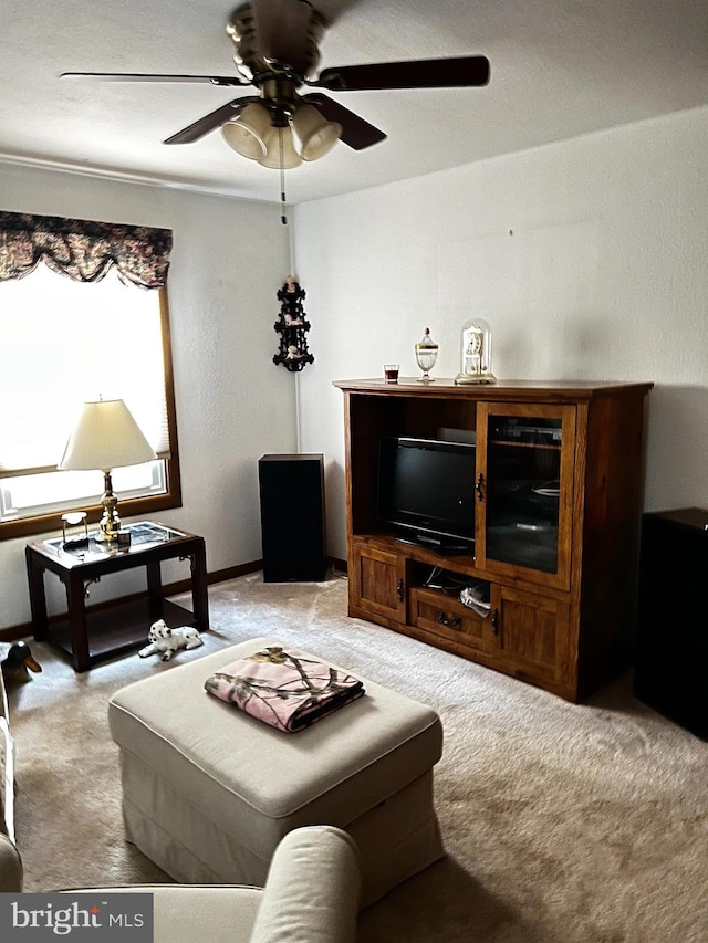 carpeted living room with ceiling fan