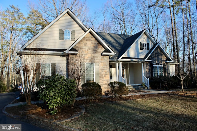 view of front of property featuring a porch and stone siding