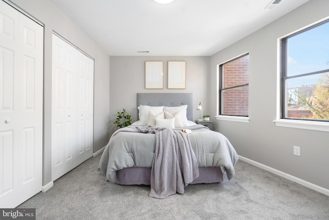 carpeted bedroom with multiple closets