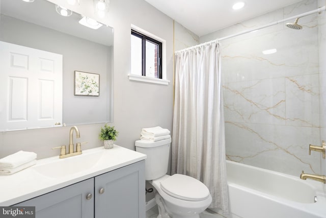 full bathroom with vanity, shower / bath combo, and toilet