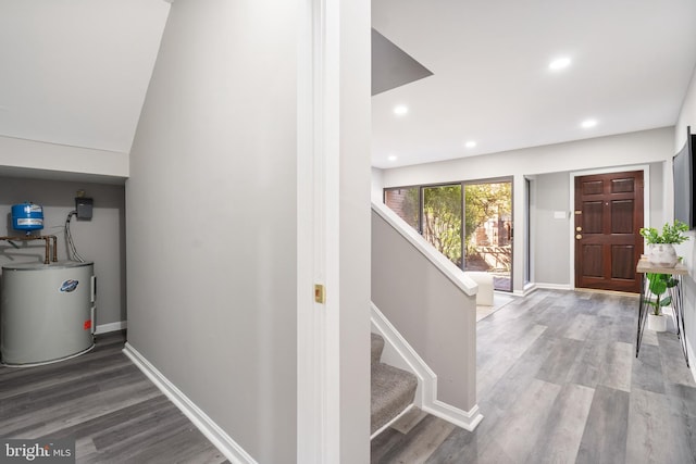 corridor featuring hardwood / wood-style flooring and water heater