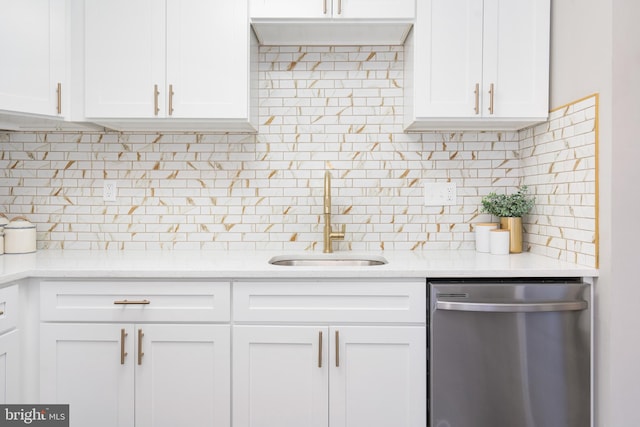 kitchen with dishwasher, white cabinetry, and sink