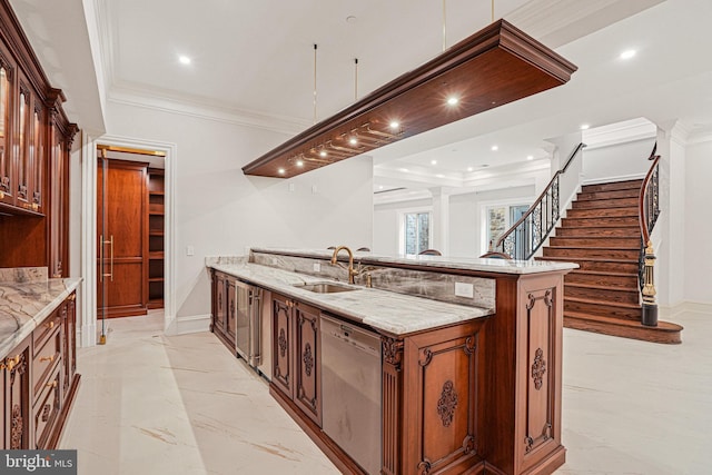 kitchen with a kitchen island with sink, ornate columns, ornamental molding, sink, and stainless steel dishwasher