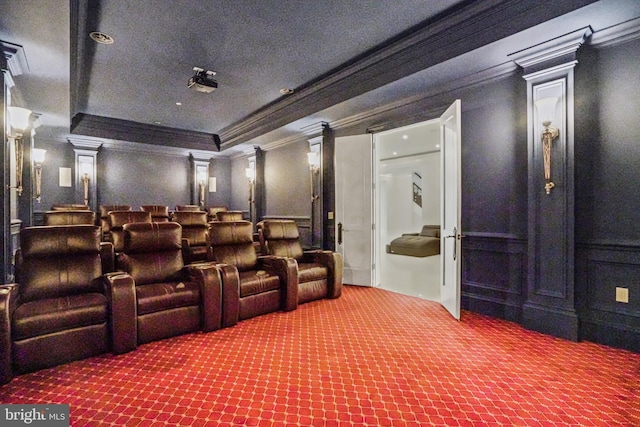 carpeted cinema with ornamental molding and ornate columns