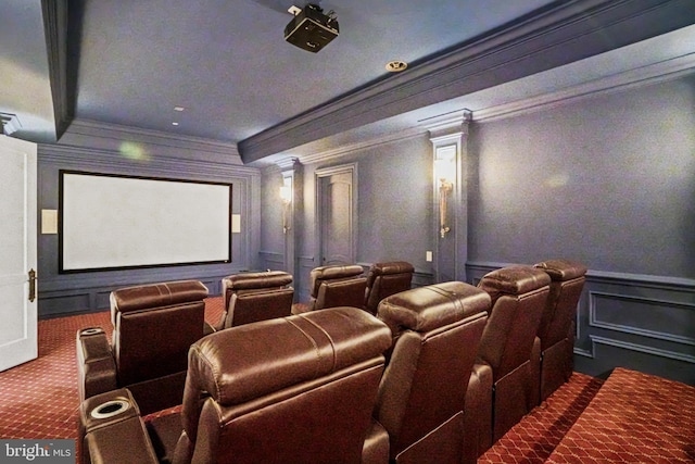 cinema room with carpet flooring, crown molding, and decorative columns