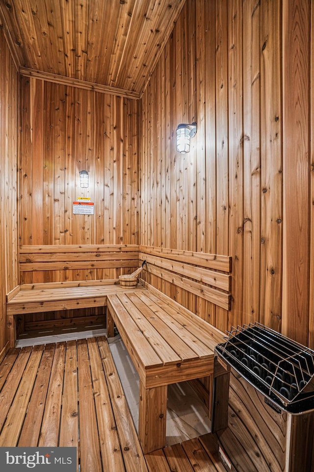 view of sauna featuring wooden walls, hardwood / wood-style flooring, and wooden ceiling