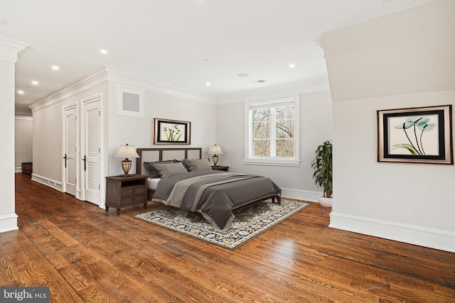 bedroom with ornate columns, crown molding, and dark hardwood / wood-style flooring