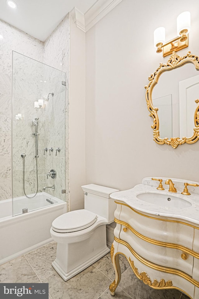 full bathroom featuring toilet, ornamental molding, vanity, tiled shower / bath combo, and tile patterned floors